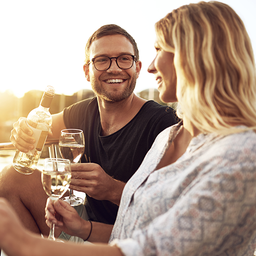 Couple Having Wine. Smiling Elite Singles.