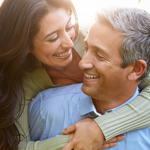 Widower Dating. Couple Cuddling & Smiling.