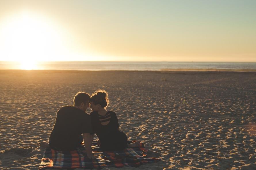 couple sitting on beach.